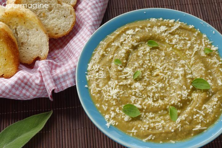 Lentil and vegetable soup in a plate served with a basket of bread