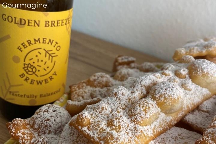A pile of freshly made chiacchiere covered with powdered sugar