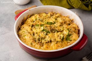 A baking dish filled with a cheese-topped courgette casserole